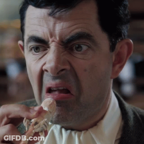 Man In Suit And Tie Eating Meat GIF