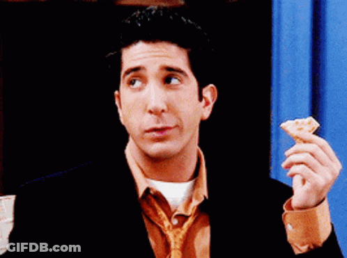 Man In Suit And Tie Eating Pizza GIF