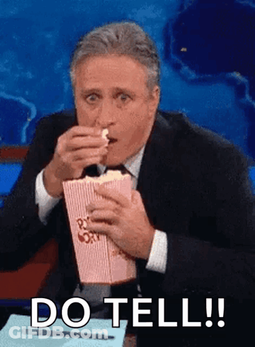Man In Suit And Tie Eating Popcorn GIF