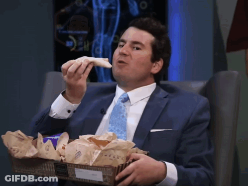 Man In Suit And Tie Eating Sandwich From Box GIF