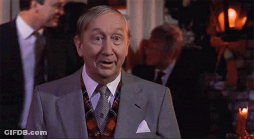 Man In Suit And Tie Facing Group GIF