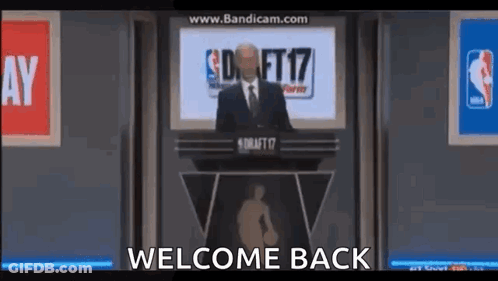 Man In Suit And Tie Gives Speech At Podium Welcome Back GIF