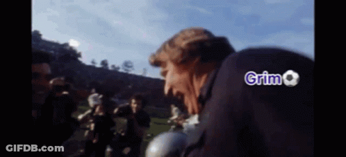 Man In Suit And Tie Giving High Five GIF