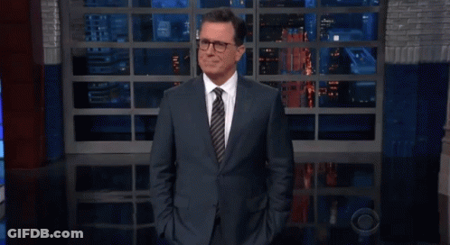 Man In Suit And Tie Hands In Pockets At Window GIF