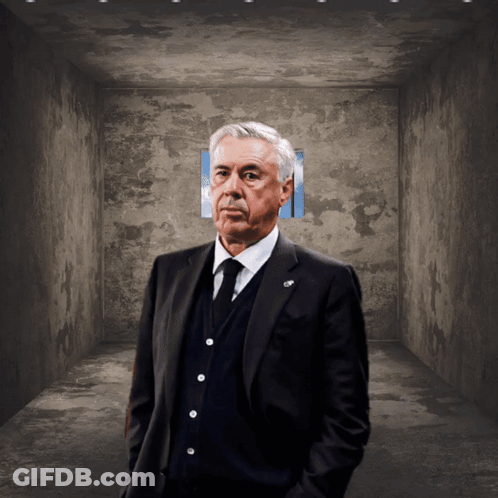 Man In Suit And Tie Hands In Pockets Dark Room GIF