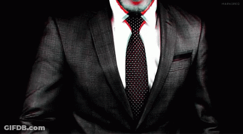 Man In Suit And Tie Hands On Chest GIF