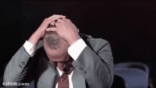 Man In Suit And Tie Hands On Head GIF