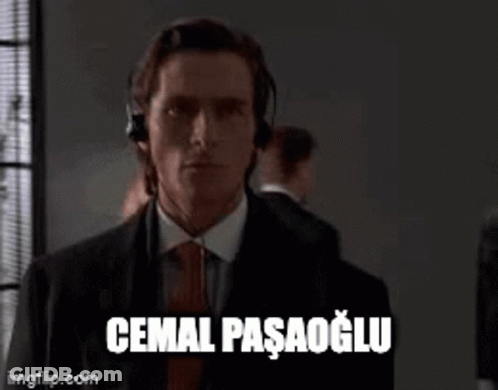Man In Suit And Tie Headphones Saying Cemal Pasagolu GIF