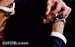 Man In Suit And Tie Holding Bloody Iron Man Glove GIF
