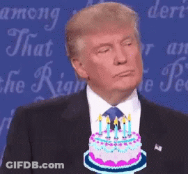 Man In Suit And Tie Holding Cake With Candles GIF