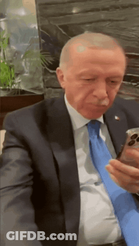 Man In Suit And Tie Holding Cell Phone GIF