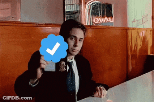 Man In Suit And Tie Holding Check Mark GIF