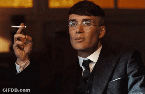 Man In Suit And Tie Holding Cigarette GIF