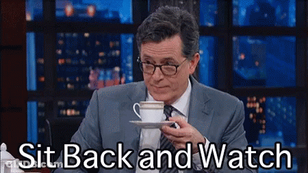 Man In Suit And Tie Holding Coffee Saying Sit Back And Watch GIF