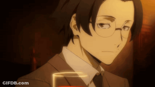 Man In Suit And Tie Holding Glass Of Red Liquid GIF