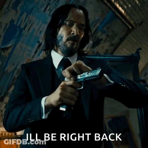Man In Suit And Tie Holding Gun GIF