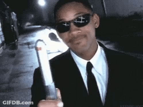 Man In Suit And Tie Holding Gun With Sunglasses GIF