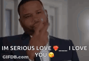 Man In Suit And Tie Holding Hand To Chin GIF