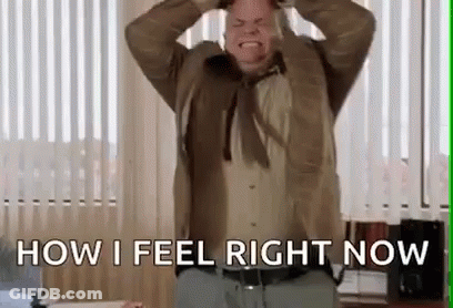 Man In Suit And Tie Holding Head And Screaming GIF