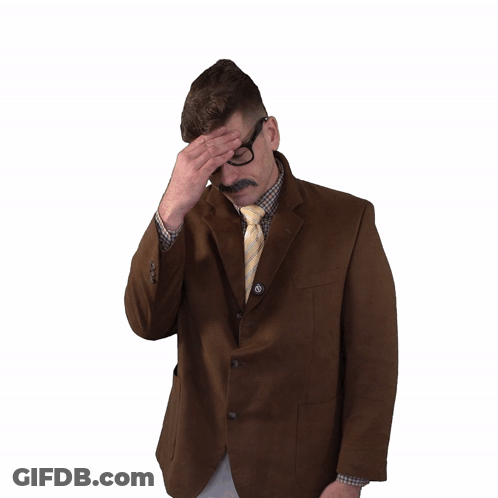 Man In Suit And Tie Holding Head In Pain GIF
