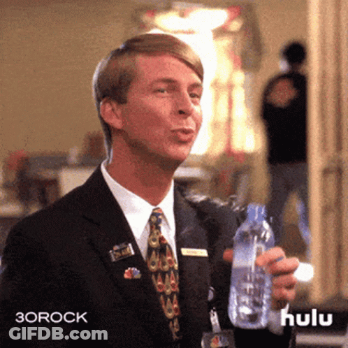 Man In Suit And Tie Holding Hulu Water Bottle GIF