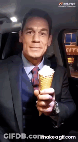 Man In Suit And Tie Holding Ice Cream Cone GIF