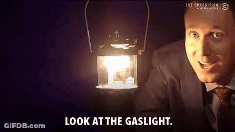 Man In Suit And Tie Holding Lantern Look At Gaslight GIF
