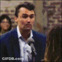 Man In Suit And Tie Holding Microphone GIF