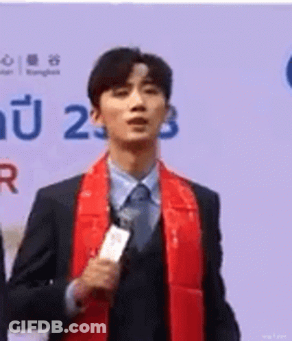 Man In Suit And Tie Holding Microphone GIF