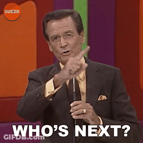 Man In Suit And Tie Holding Microphone Who's Next GIF