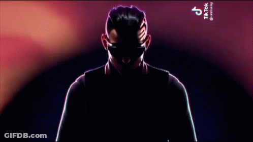 Man In Suit And Tie Holding Microphone With TikTok GIF