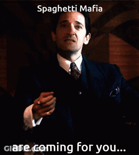 Man In Suit And Tie Holding Paper Saying Spaghetti Mafia Are Coming For You GIF