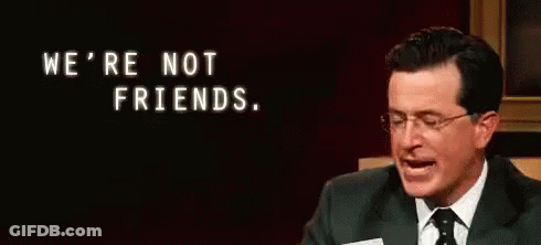 Man In Suit And Tie Holding Paper Saying We're Not Friends GIF