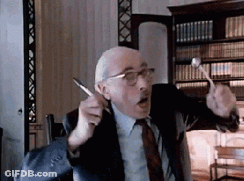 Man In Suit And Tie Holding Pen And Hammer GIF
