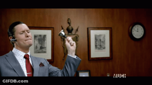 Man In Suit And Tie Holding Pen Near Clock Saying Much GIF