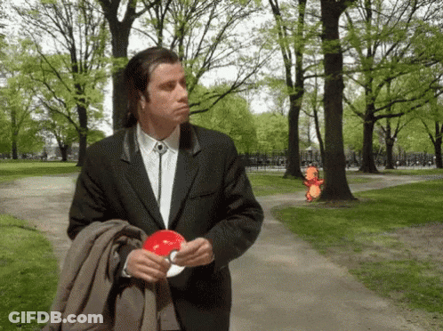 Man In Suit And Tie Holding Red Object GIF