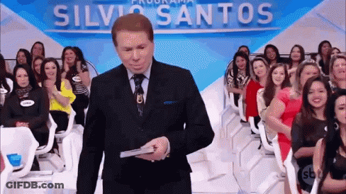 Man In Suit And Tie Holding Silva Santos Sign GIF