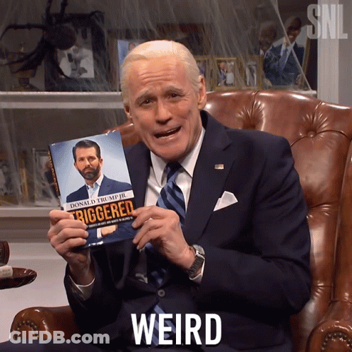 Man In Suit And Tie Holding Triggered Book GIF
