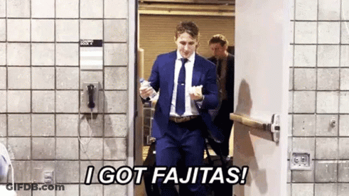Man In Suit And Tie Holding Water Bottle In Doorway GIF
