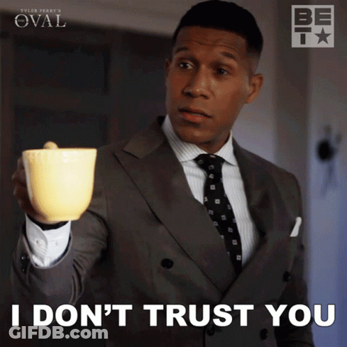 Man In Suit And Tie Holding Yellow Cup Says I Don't Trust You GIF