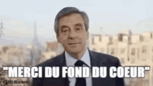 Man In Suit And Tie In City Says Merci Du Fond Du Coeur GIF