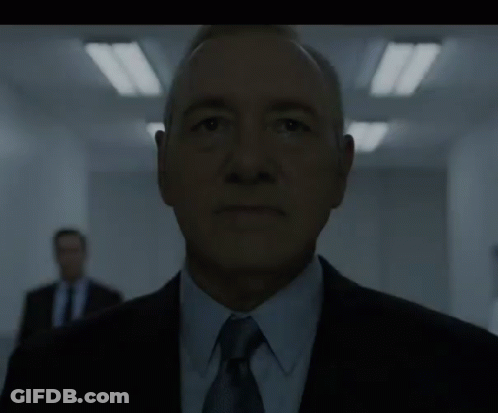 Man In Suit And Tie In Dark Room GIF