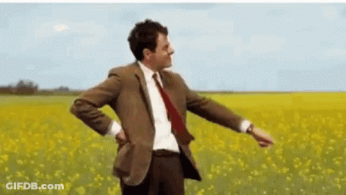 Man In Suit And Tie In Flower Field GIF