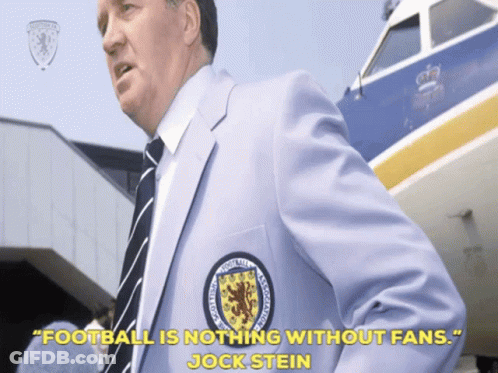Man In Suit And Tie In Front Of Airplane GIF