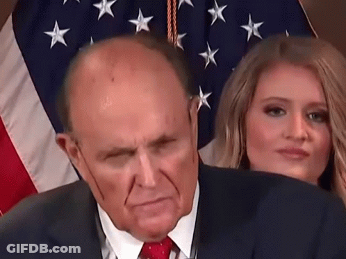 Man In Suit And Tie In Front Of American Flag GIF