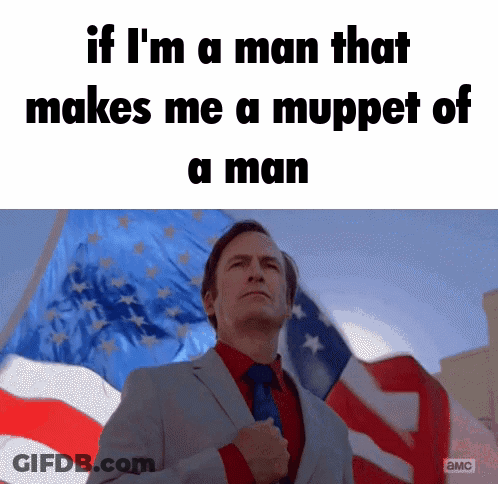 Man In Suit And Tie In Front Of American Flag With Fist In Pocket GIF