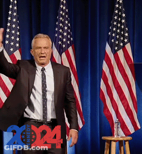 Man In Suit And Tie In Front Of American Flags 2014 GIF