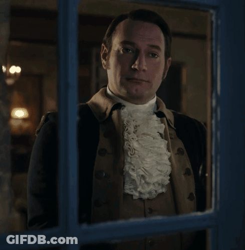 Man In Suit And Tie In Front Of Bookshelf Saying Order GIF