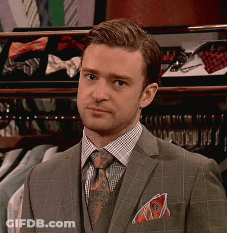 Man In Suit And Tie In Front Of Bow Tie Display GIF