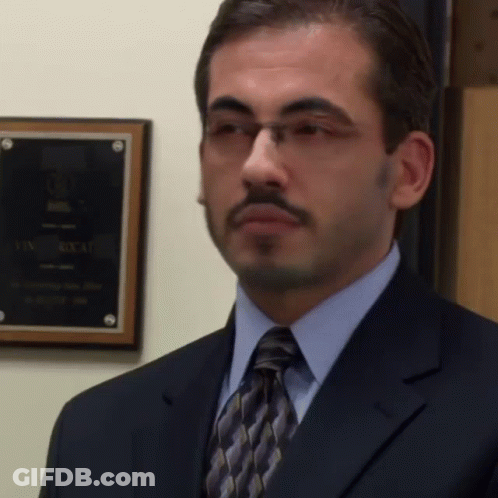 Man In Suit And Tie In Front Of Box Plaque GIF